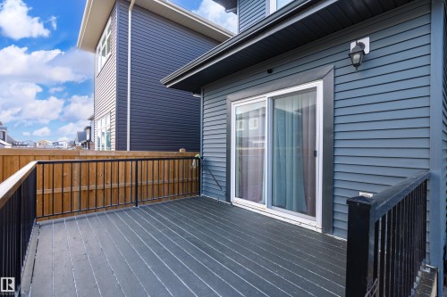 Private deck space featuring dark composite decking and black metal railings - 2 Edison Drive, St. Albert, AB - Outdoor With Deck Patio Veranda With Exterior