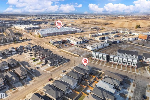 Aerial perspective showcasing a residential neighborhood with mixed-style homes and commercial establishments - 2 Edison Drive, St. Albert, AB - Outdoor With View