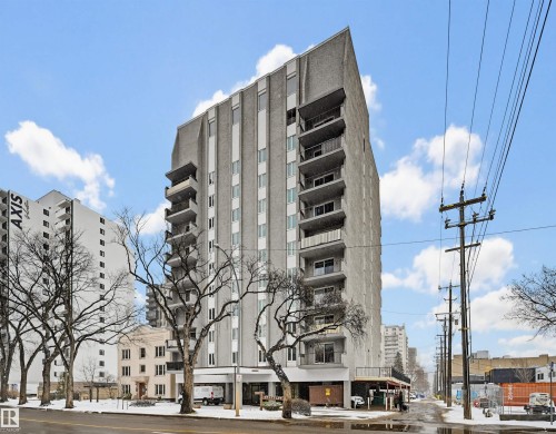 High-rise building featuring a textured facade, multiple private balconies, and ground-level commercial spaces - 701 10135 116 Street Nw, Edmonton, AB - Outdoor With Facade