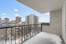 Exterior balcony with a black metal railing and textured white brick wall - 701 10135 116 Street Nw, Edmonton, AB  - Outdoor With Exterior 