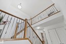 The property features a staircase with wooden handrails and metal balusters - 1115 61 Street, Edmonton, AB  - Indoor Photo Showing Other Room 