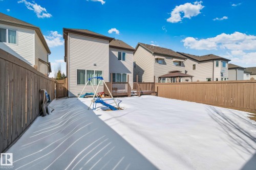 The property features a fenced yard with a deck and a sliding glass door - 1115 61 Street, Edmonton, AB - Outdoor With Exterior