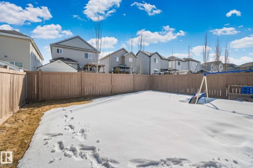 This property features a fenced backyard with a snow-covered lawn - 1115 61 Street, Edmonton, AB - Outdoor