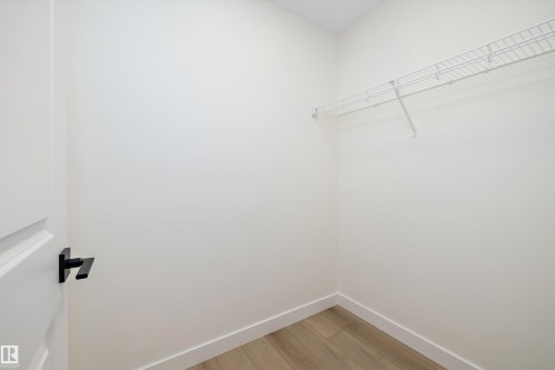 Interior closet featuring light wood-finish flooring and white baseboards - 11418 96 Street, Edmonton, AB - Indoor With Storage