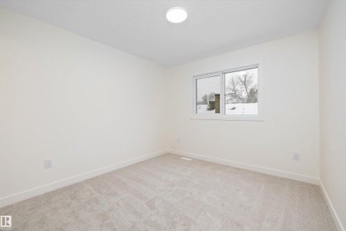 Room featuring light-toned walls, white trim, and neutral carpeting - 11418 96 Street, Edmonton, AB - Indoor Photo Showing Other Room