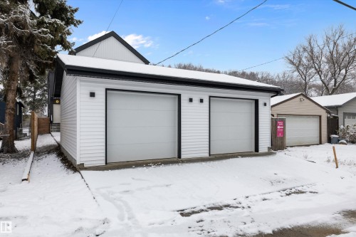 Detached two-car garage with white horizontal siding and black trim accents - 11418 96 Street, Edmonton, AB - Outdoor