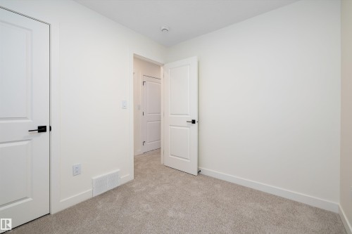 Neutral toned wall paint with matching baseboards - 11918 93 Street, Edmonton, AB - Indoor Photo Showing Other Room