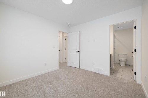 Light-toned carpeting in a neutral room with white walls and baseboards - 11918 93 Street, Edmonton, AB - Indoor Photo Showing Other Room