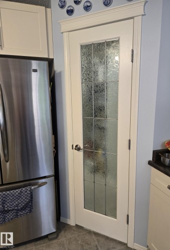 White paneled door featuring multiple textured glass inserts - 59 Rue Monette, Beaumont, AB - Indoor