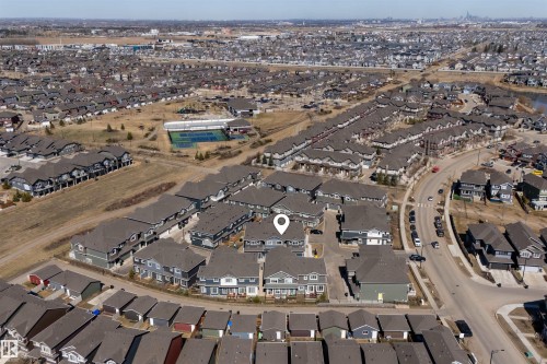 Aerial perspective of a residential community featuring a variety of housing styles - 51 603 Orchards Boulevard Sw, Edmonton, AB - Outdoor With View