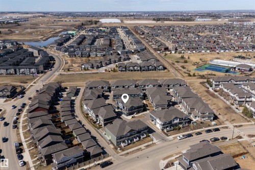 Aerial perspective showcasing a residential community with varied architectural styles - 51 603 Orchards Boulevard Sw, Edmonton, AB - Outdoor With View