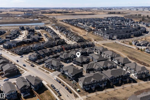 Aerial perspective showcasing a residential community with varied architectural styles - 51 603 Orchards Boulevard Sw, Edmonton, AB - Outdoor With View