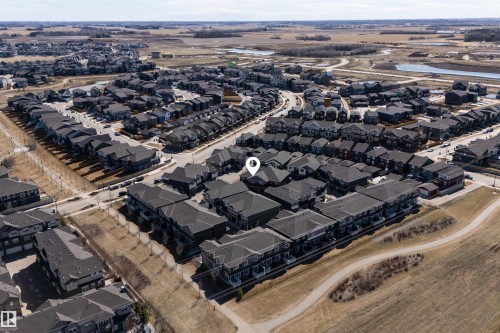 Aerial perspective showcasing a residential community with varied housing styles - 51 603 Orchards Boulevard Sw, Edmonton, AB - Outdoor With View