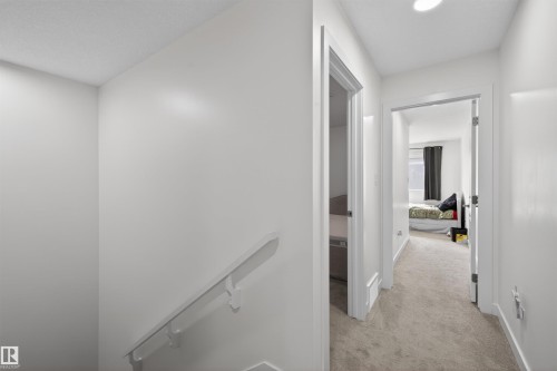 Carpeted hallway with white walls, recessed lighting, and white trim - 51 603 Orchards Boulevard Sw, Edmonton, AB - Indoor Photo Showing Other Room