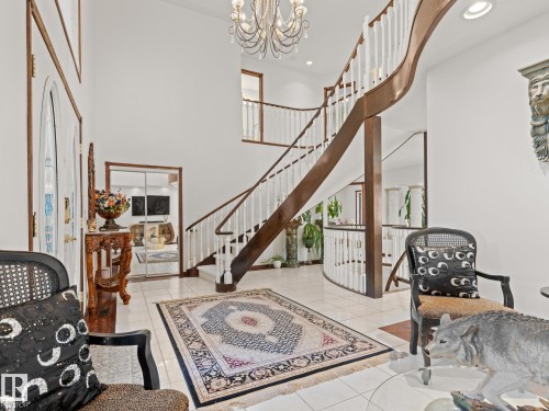 Foyer entrance featuring a chandelier, a towering ceiling, light tile patterned floors, recessed lighting, and healthy amount of natural light - 29 Oakdale Place, St. Albert, AB - Indoor Photo Showing Other Room