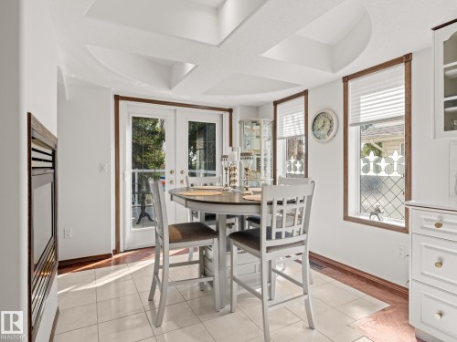 Dining area featuring light tile patterned floors and french doors - 29 Oakdale Place, St. Albert, AB - Indoor Photo Showing Dining Room
