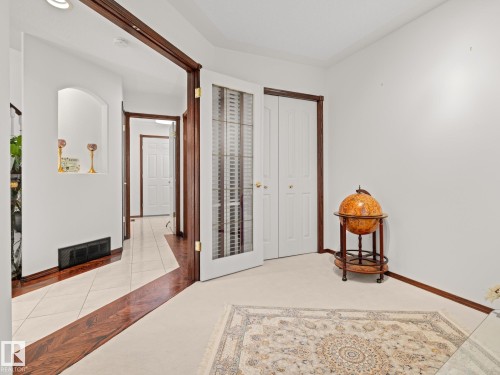 Bedroom featuring a closet, light tile patterned floors, and light carpet - 29 Oakdale Place, St. Albert, AB - Indoor Photo Showing Other Room
