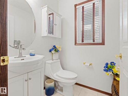 Half bath with vanity and light tile patterned floors - 29 Oakdale Place, St. Albert, AB - Indoor Photo Showing Bathroom