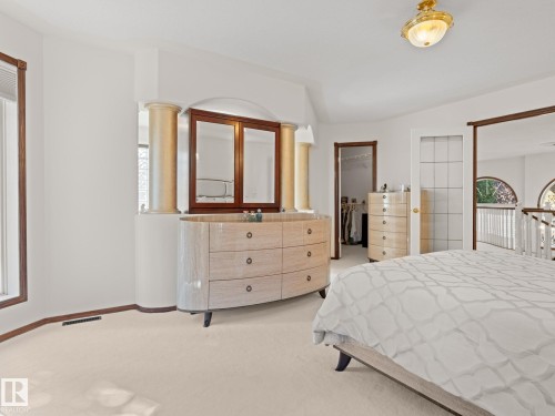 Bedroom with light carpet and a walk in closet - 29 Oakdale Place, St. Albert, AB - Indoor Photo Showing Bedroom