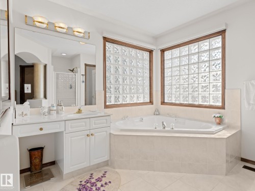 Bathroom featuring a garden tub, a shower stall, healthy amount of natural light, and vanity - 29 Oakdale Place, St. Albert, AB - Indoor Photo Showing Bathroom