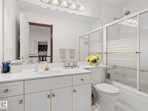 Full bathroom featuring bath / shower combo with glass door, vanity, and light tile patterned floors - 29 Oakdale Place, St. Albert, AB - Indoor Photo Showing Bathroom