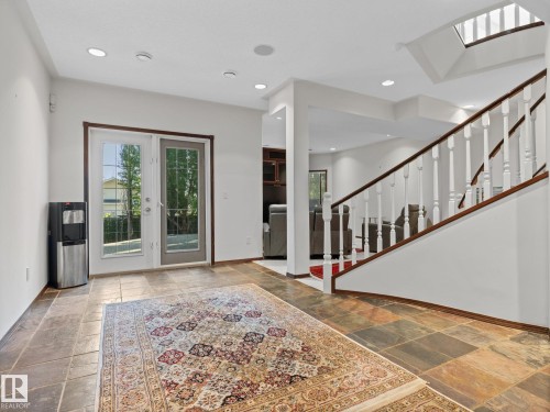 Foyer entrance featuring plenty of natural light, stairway, recessed lighting, and stone tile floors - 29 Oakdale Place, St. Albert, AB - Indoor Photo Showing Other Room