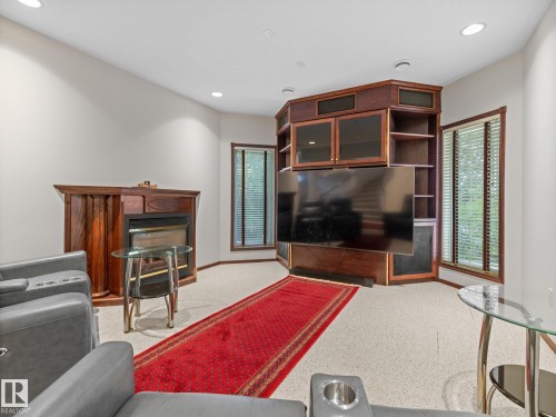 Carpeted living room with recessed lighting, plenty of natural light, and a fireplace - 29 Oakdale Place, St. Albert, AB - Indoor Photo Showing Other Room