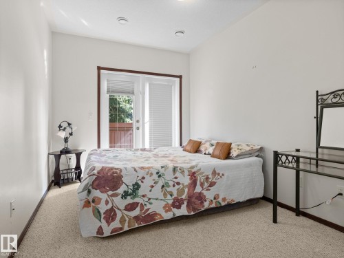 Bedroom with access to outside and carpet - 29 Oakdale Place, St. Albert, AB - Indoor Photo Showing Bedroom