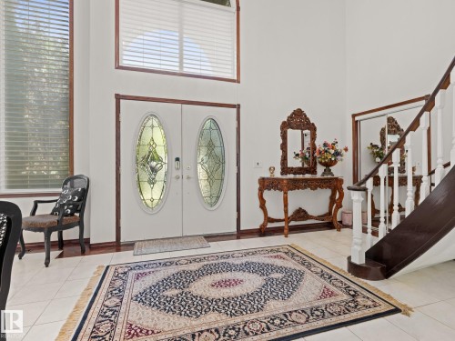 Entryway featuring light tile patterned floors, a high ceiling, stairway, and french doors - 29 Oakdale Place, St. Albert, AB - Indoor Photo Showing Other Room