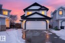 The property features a two-story exterior with white siding and dark trim, illuminated by exterior lighting - 3518 18 Street, Edmonton, AB  - Outdoor 