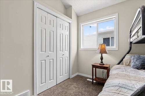 This room features light neutral walls, carpeted flooring, and a window providing natural light - 3518 18 Street, Edmonton, AB - Indoor Photo Showing Bedroom