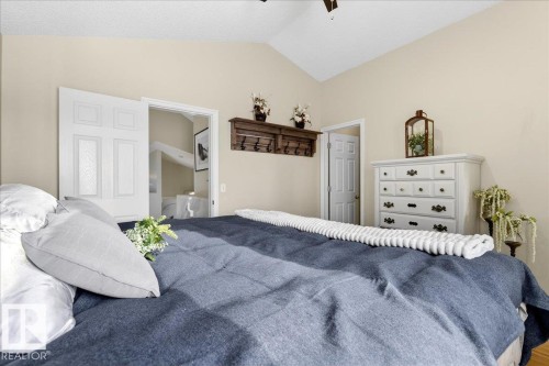 Bedroom featuring vaulted ceilings and a paneled door - 3518 18 Street, Edmonton, AB - Indoor Photo Showing Bedroom