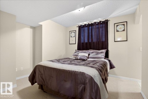 This room features light-colored walls, carpeted flooring, and a ceiling light fixture - 3518 18 Street, Edmonton, AB - Indoor Photo Showing Bedroom