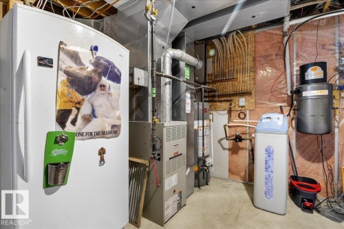 The property includes a water softener system and a water heater, alongside visible utility infrastructure - 3518 18 Street, Edmonton, AB - Indoor Photo Showing Basement