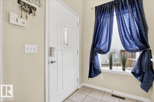 The property features a white paneled entry door with decorative glass inserts and a digital lock - 3518 18 Street, Edmonton, AB - Indoor