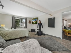 Spacious with light gray walls, and an overhead beam - 