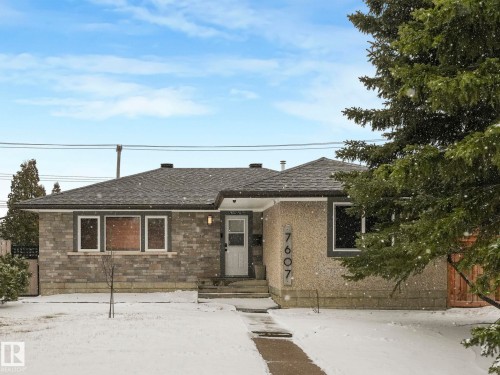Exterior featuring a grey shingle roof, stone veneer siding, and a stucco finish - 7607 70 Avenue, Edmonton, AB 
