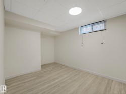 Room with drop ceiling with recessed lighting, and a horizontal window with blinds. Easily converted to a bedroom by resizing window into an egress window. - 