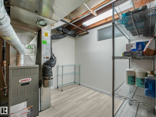 Utility room featuring a Lennox furnace and ample storage shelving - 7607 70 Avenue, Edmonton, AB 