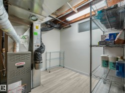 Utility room featuring a Lennox furnace and ample storage shelving - 