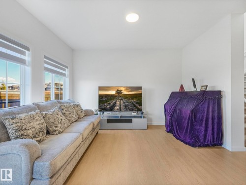 Bright living space featuring light wood-finish flooring, white walls, and recessed lighting - 4851 Kinney Road, Edmonton, AB - Indoor Photo Showing Living Room
