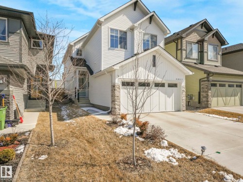 Modern two-story residence featuring white siding and stone accents - 4851 Kinney Road, Edmonton, AB - Outdoor