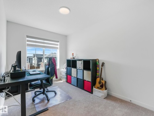 Bright room featuring a large window with horizontal blinds, neutral carpet flooring, and a flush-mount ceiling light fixture - 4851 Kinney Road, Edmonton, AB - Indoor Photo Showing Office