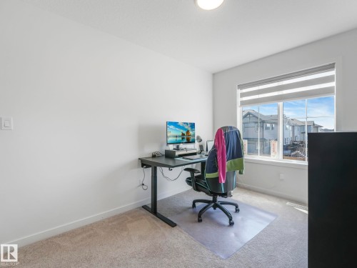 Bright interior space featuring a large window with horizontal blinds, providing ample natural light - 4851 Kinney Road, Edmonton, AB - Indoor Photo Showing Office