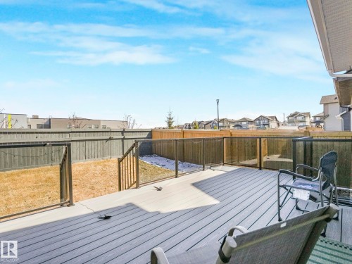 Spacious elevated deck with composite decking and glass panel railings - 4851 Kinney Road, Edmonton, AB - Outdoor With Deck Patio Veranda
