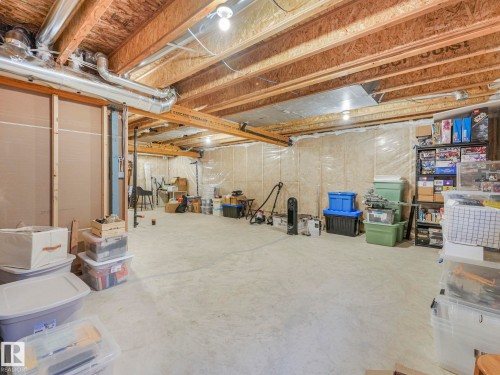 Unfinished basement offering substantial open space, exposed wood joists, and visible ductwork - 4851 Kinney Road, Edmonton, AB - Indoor Photo Showing Basement