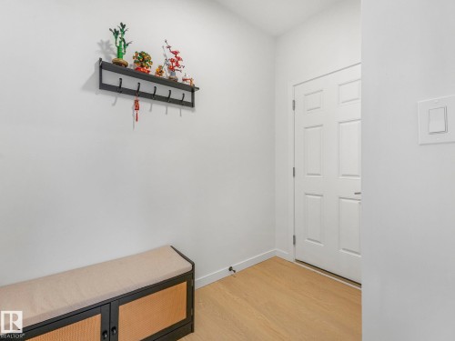 Entryway featuring light wood-finish flooring, white walls, and a paneled door - 4851 Kinney Road, Edmonton, AB - Indoor Photo Showing Other Room