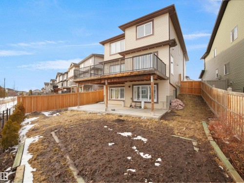 The property features a multi-level structure with beige siding and brown trim - 4231 Charles Close, Edmonton, AB - Outdoor With Deck Patio Veranda