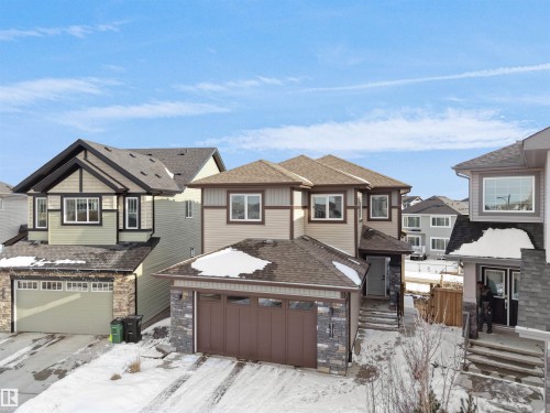 The property features a multi-level design with a brown roof and a tan and brown exterior - 4231 Charles Close, Edmonton, AB - Outdoor