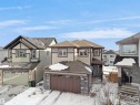 The property features a multi-level design with a brown roof and a tan and brown exterior - 4231 Charles Close, Edmonton, AB  - Outdoor 